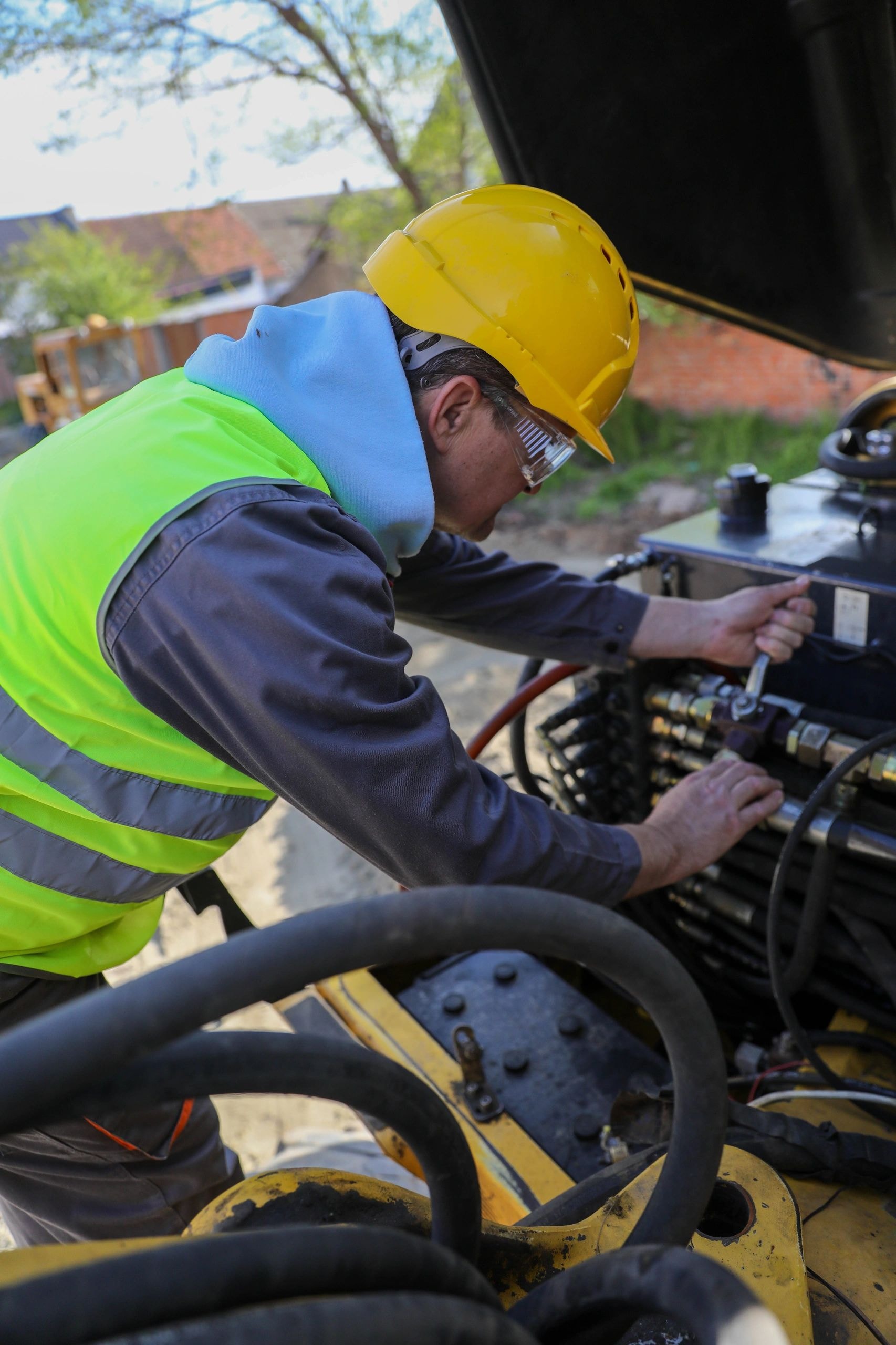 Hydraulic technician working on industrial equipment